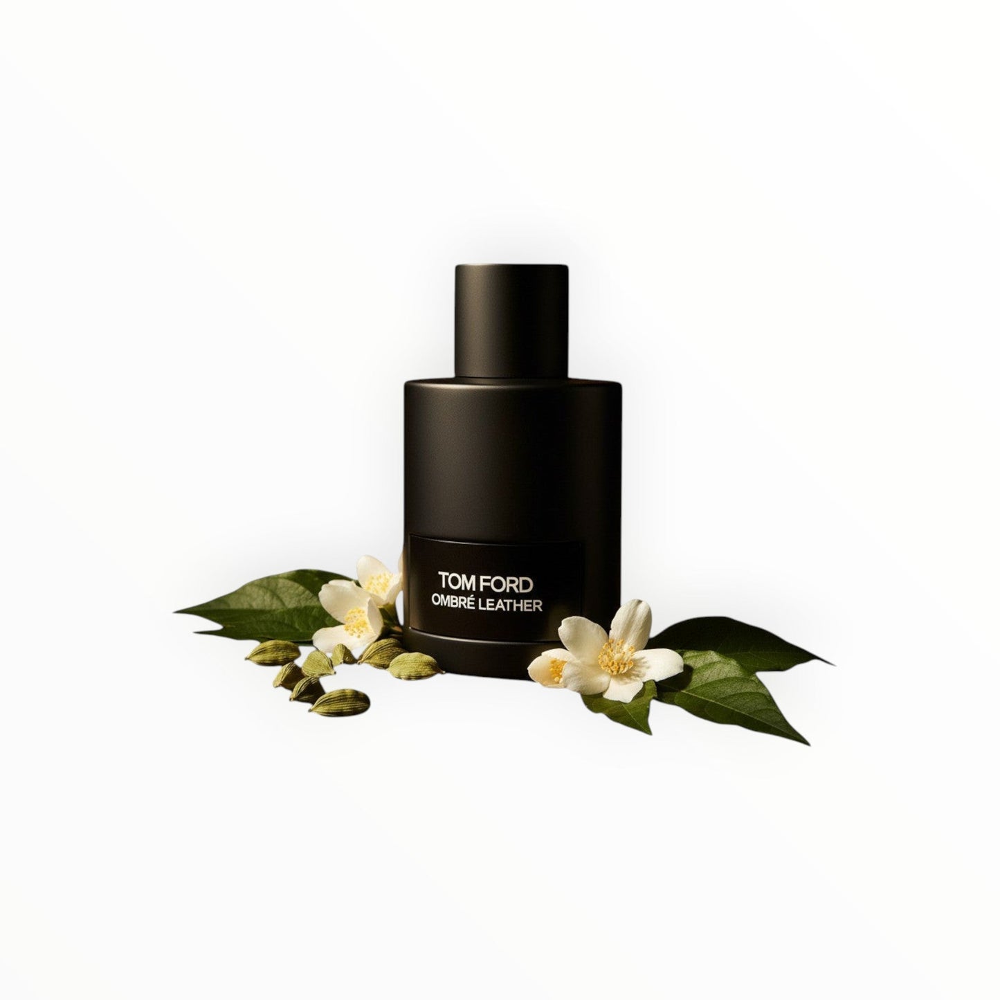 Tom Ford Ombré Leather Eau de Parfum in a matte black bottle with cardamom pods and white jasmine flowers.